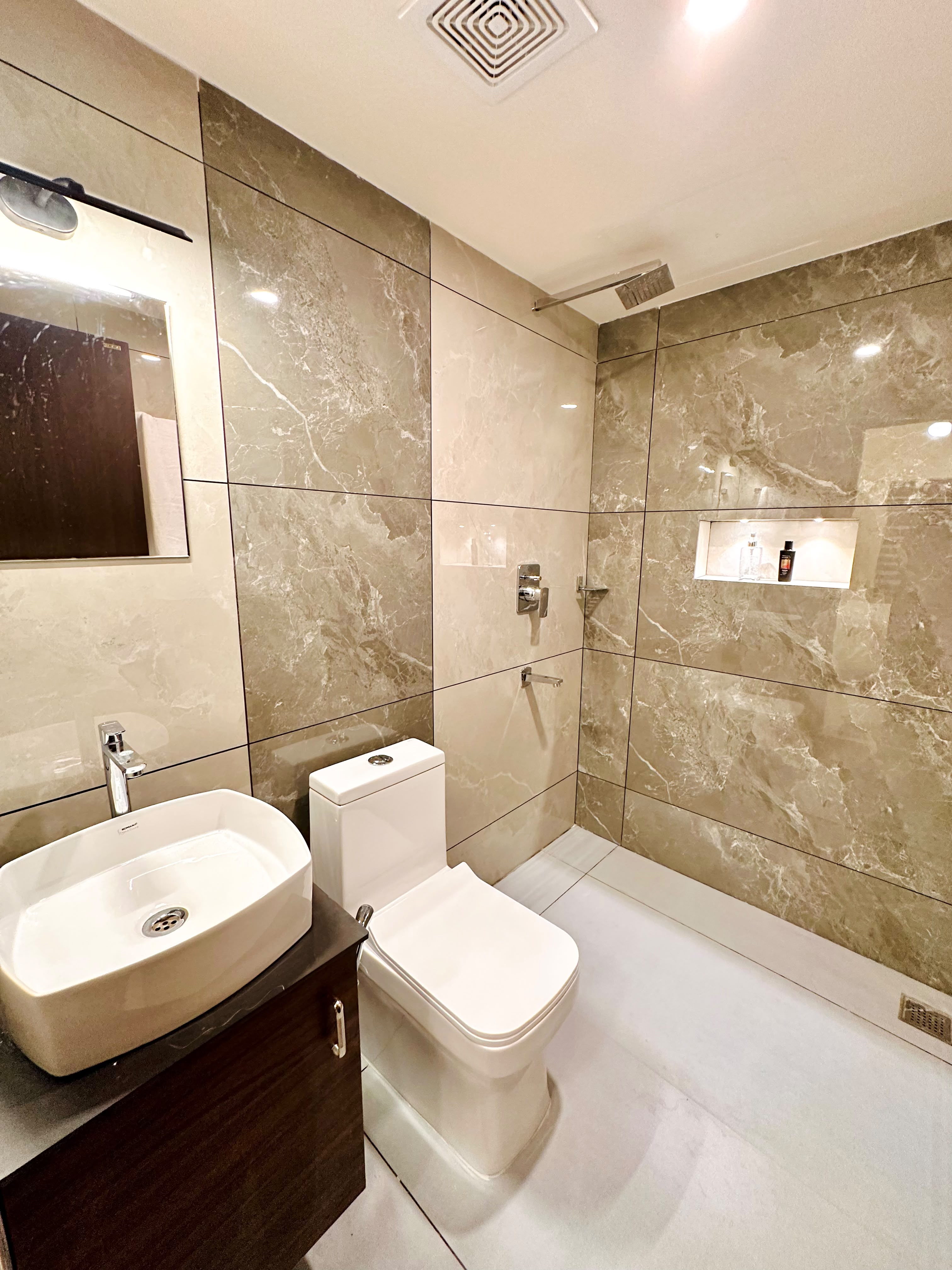 Bathroom vanity and shower at Global Residency